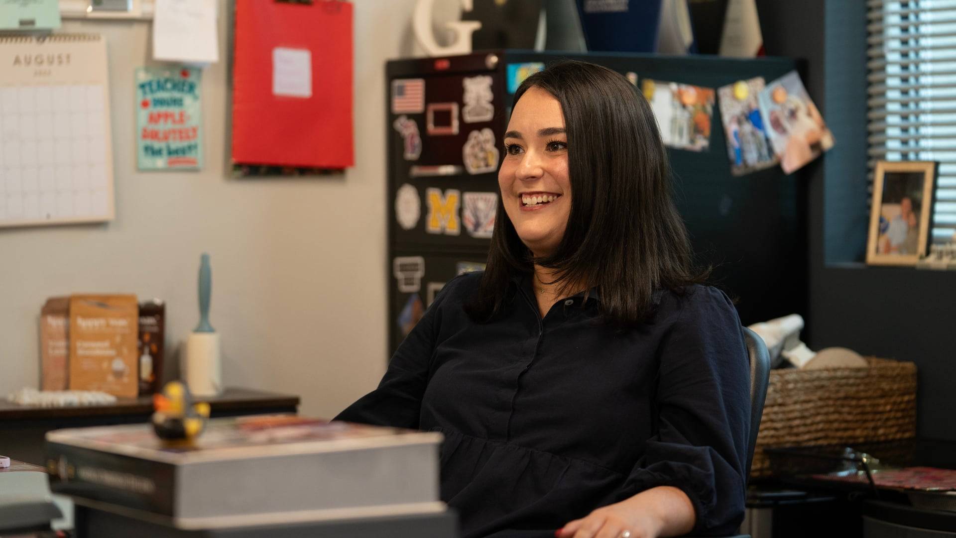 Gloria Masterson Hunter smiles at her office desk